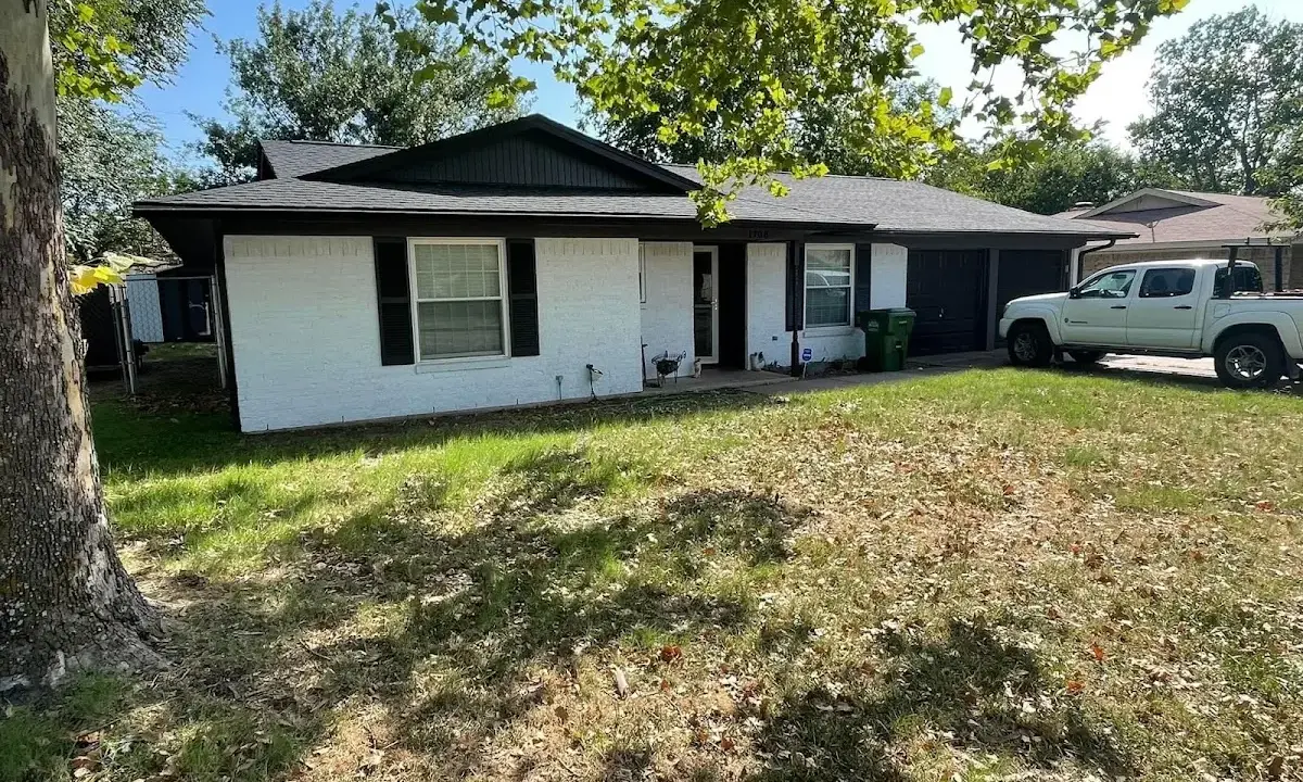 Professional roofing crew working on a residential roof in Belding